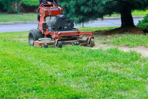 man cutting lawn on commercial lawnmower